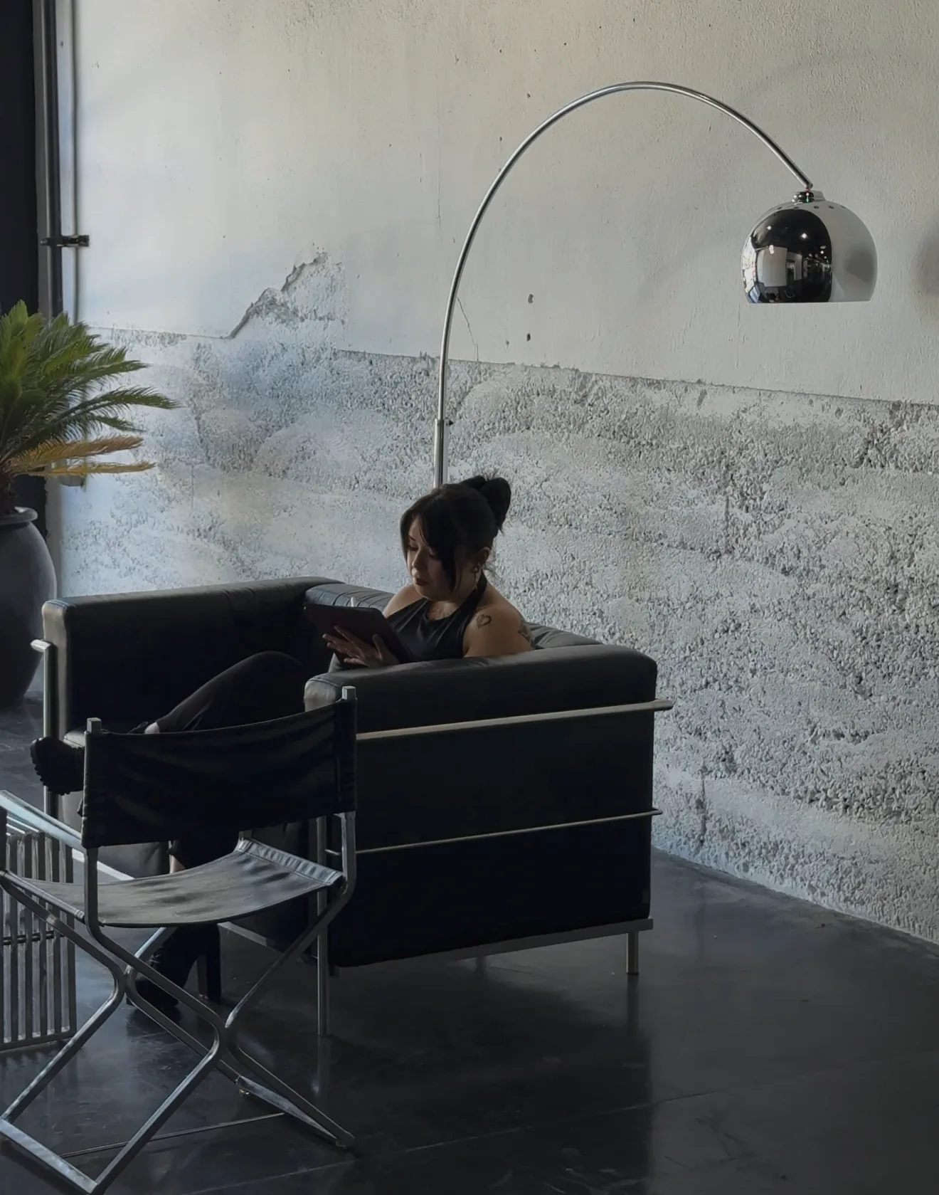 Audreyanna seated in the studio working on a drawing