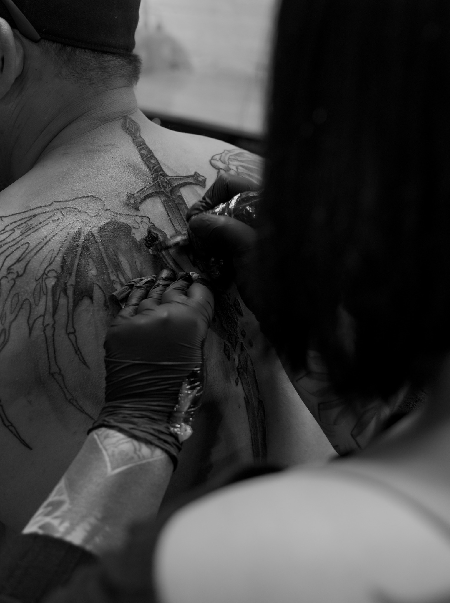 Audreyanna tattooing a large back piece